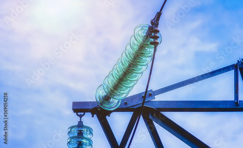 High-voltage tower wires. The insulator of the transmission line in close-up.