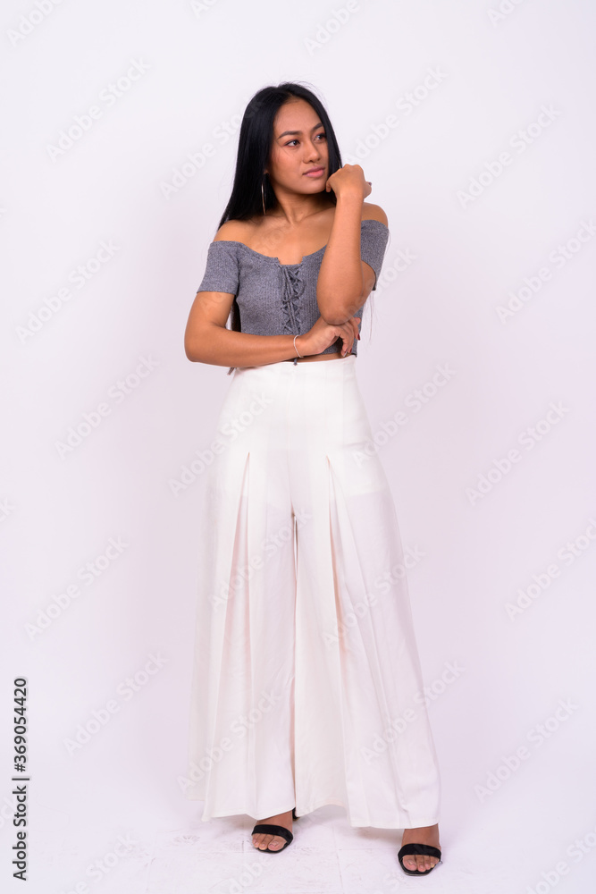 Young beautiful Asian woman against white background Young beautiful Asian woman against white background