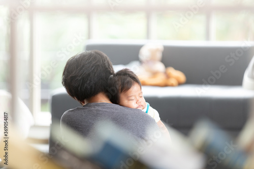 Asian cute baby sleeping on his mother's shoulder in living room. Healthcare and medical love, lifestyle mother's day concept.