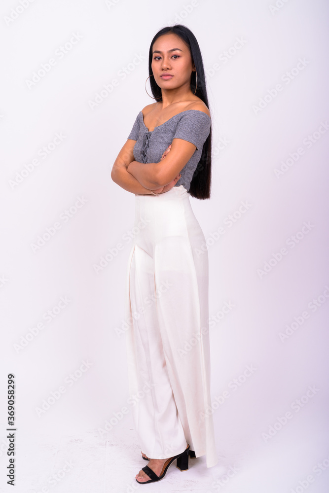 Young beautiful Asian woman against white background Young beautiful Asian woman against white background