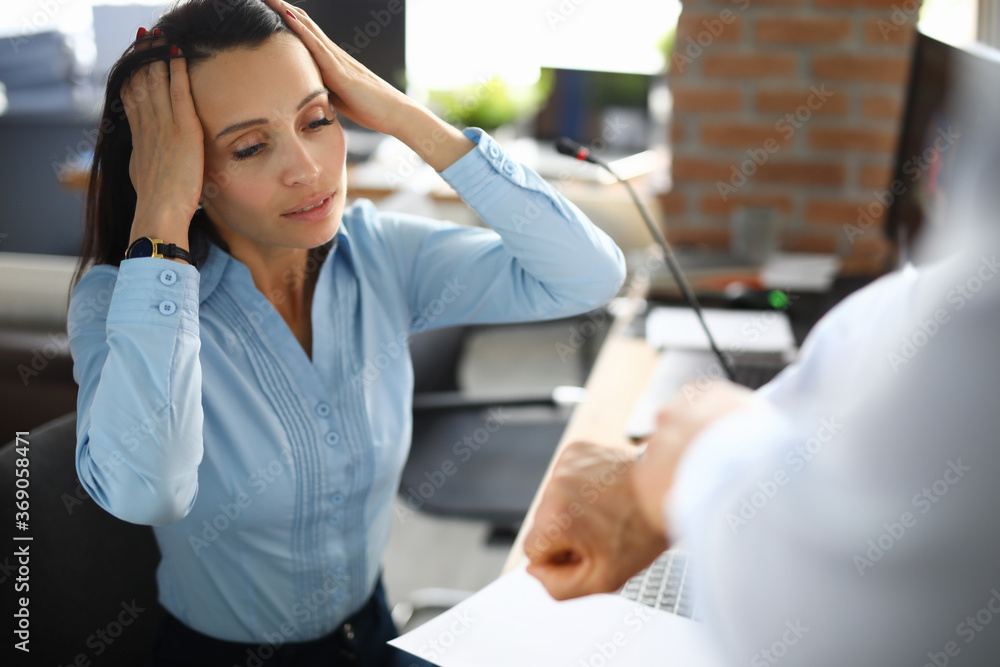 Woman holding her head in stress employer shows clock. Working time planning and deadlines concept Woman holding her head in stress employer shows clock. Working time planning and deadlines concept