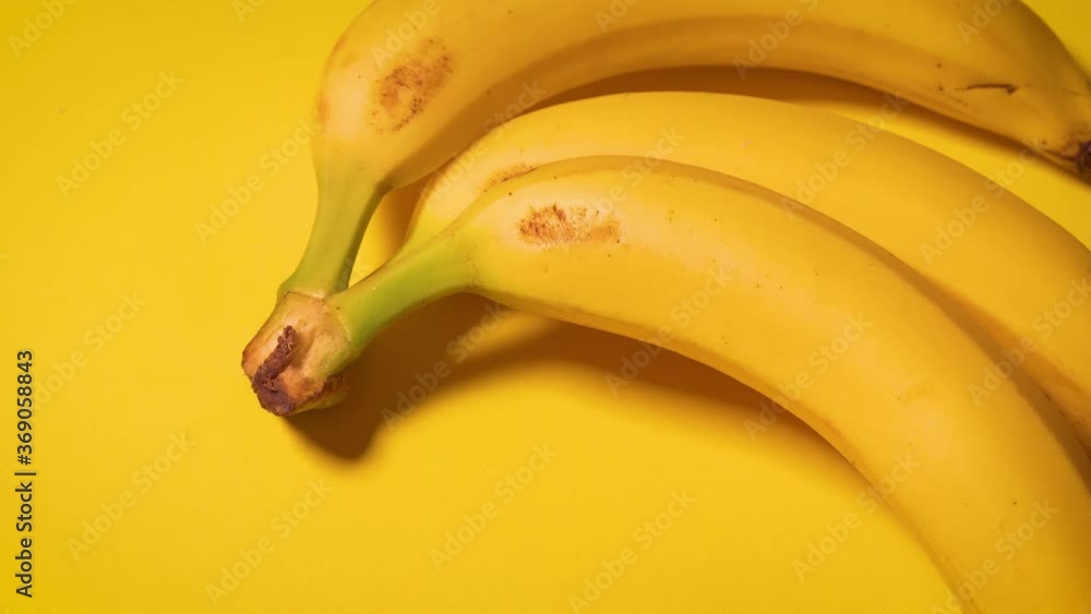 fresh bananas on a yellow minimalistic background fresh bananas on a yellow minimalistic background