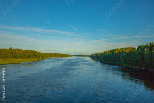 wooded banks of a wide river