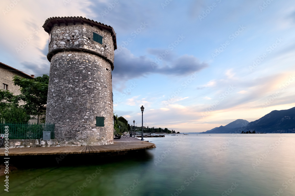The ancient tower of the Cassone marina and the Lake Garda. Malcesine, Verona province, Veneto, Italy, Europe.
