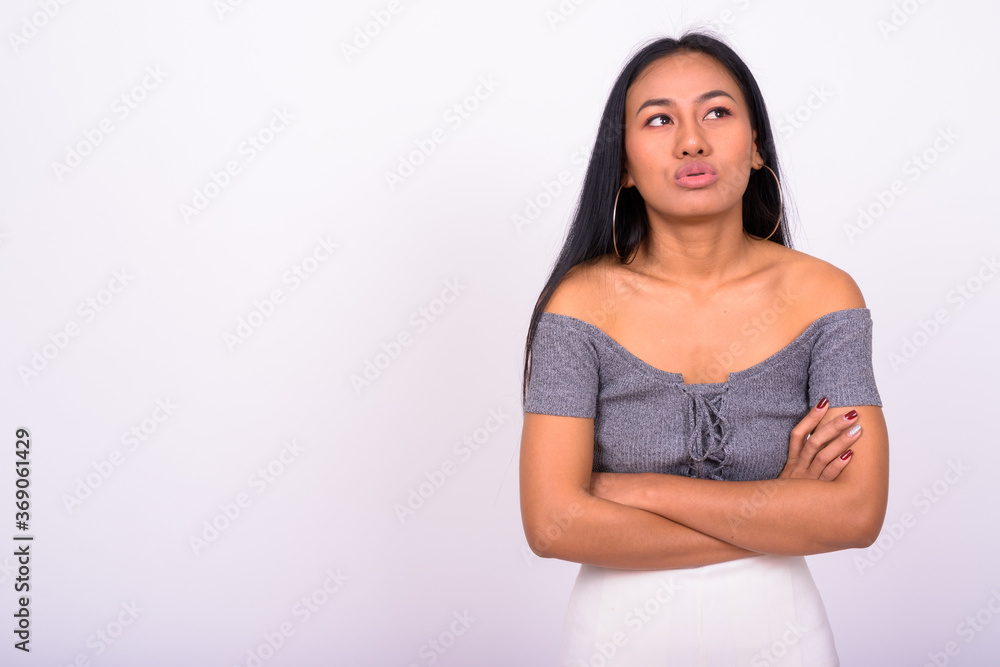 Young beautiful Asian woman against white background Young beautiful Asian woman against white background