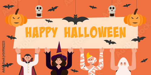 Children in Halloween costume carry Happy Halloween banner.
