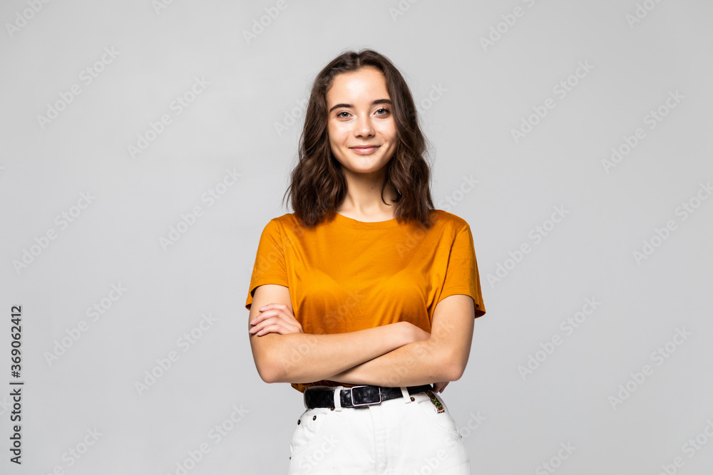 Portrait of beautiful young woman standing on grey background - obrazy, fototapety, plakaty 