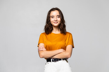 Portrait of beautiful young woman standing on grey background