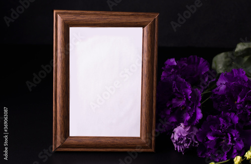 Empty mourning photo frame on black background