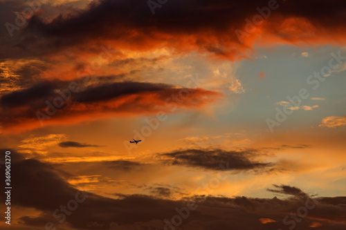 Plane on red sky in sunset