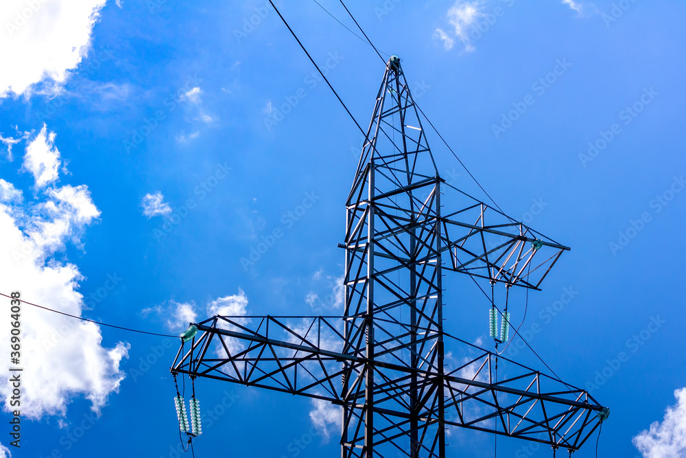 High-voltage tower with power lines and insulators. The metal structure ...