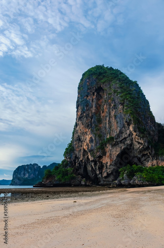 Deserted beach against the backdrop of rocks at low tide in Thailand