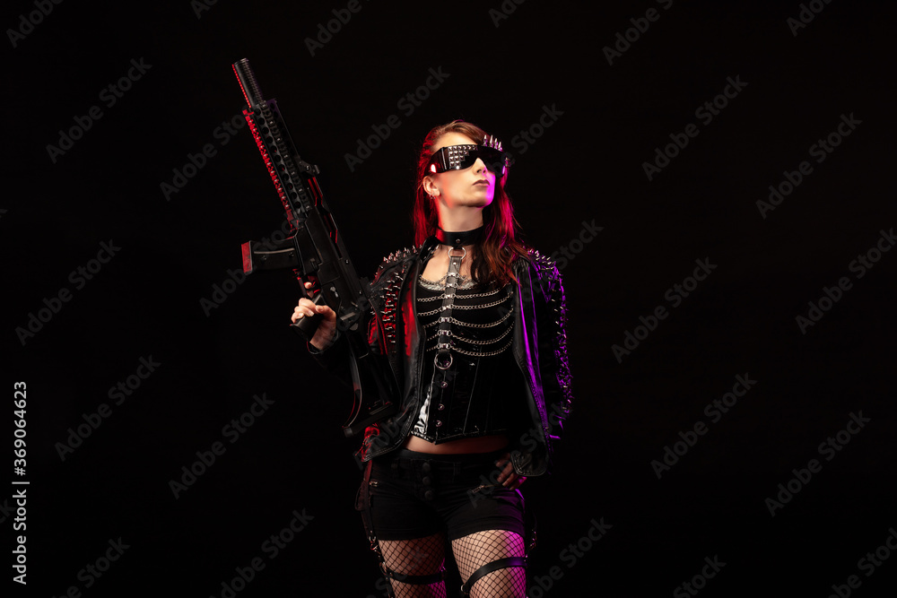 Young woman dressed in a studded leather jacket, a pair of cyberpunk glasses, holding an assault rifle in her hands