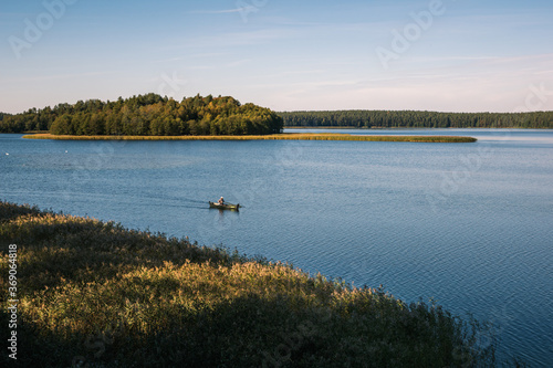 Angler in a boat on the Wigry lake near Wigierski National Park, Podlaskie, Poland photo