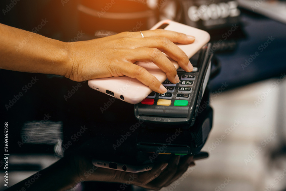 Payment transaction with smartphone in market Payment transaction with smartphone in market