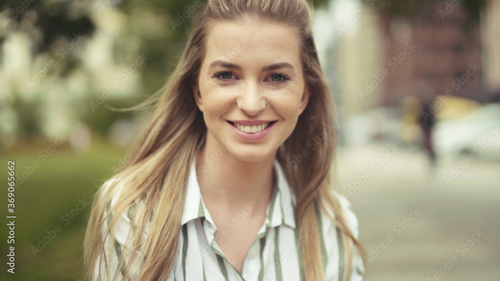 Portrait of beautiful young blonde woman in a city. Portrait of beautiful young blonde woman in a city.