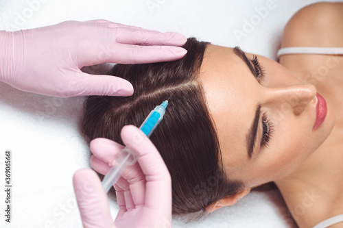 Injection hair mesotherapy. The procedure for improving the skin of the scalp of a woman.