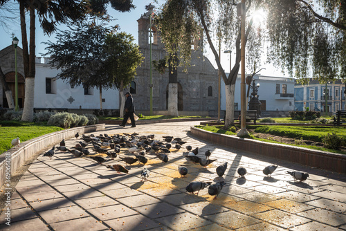 Riobamba/Ecuador - circa 2013. Catheredrale of Riobamba, catholic church. On the square people meet, feed pigeons and enjoy the sun