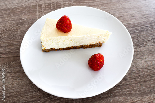 american cheesecake with strawberries on wodden table