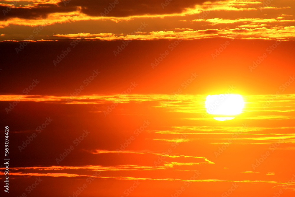 orange sun in the sky at sunset orange sun in the sky at sunset