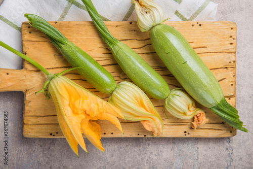 Zucchini and zucchini flower on concrte  background. Organic food. photo