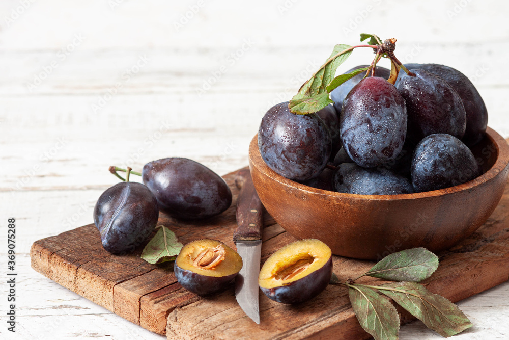 Fresh plums on white wooden table. Fresh plums on white wooden table.