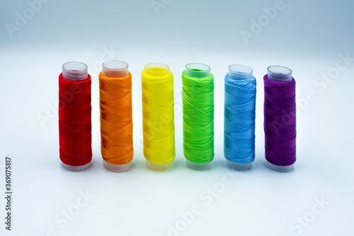 Rainbow made of colourful thread spools isolated on a white background. Lgbt and love symbol. Lesbian, gay, bisexual, transgender community rights support concept.