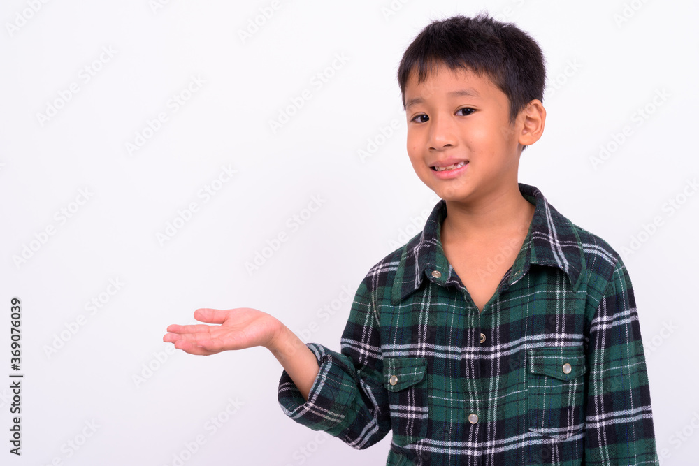 Studio shot of cute Asian boy against white background Studio shot of cute Asian boy against white background