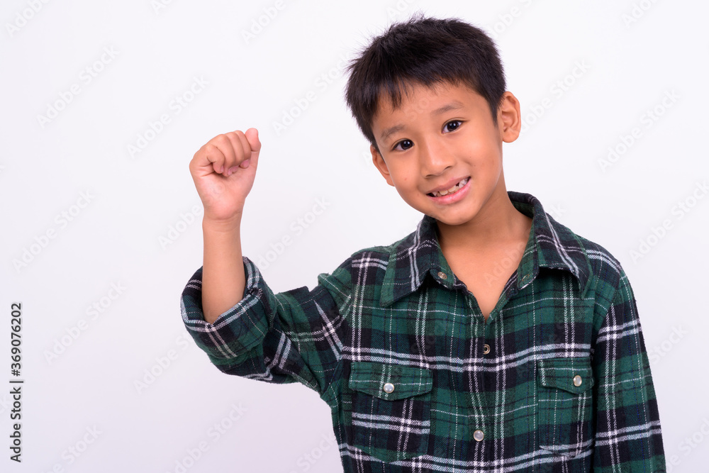Studio shot of cute Asian boy against white background Studio shot of cute Asian boy against white background