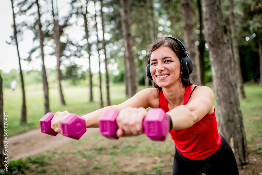 Young woman working out with a dumbbells Young woman working out with a dumbbells