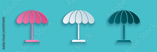 Paper cut Sun protective umbrella for beach icon isolated on blue background. Large parasol for outdoor space. Beach umbrella. Paper art style. Vector Illustration.
