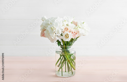 Bouquet of roses, eustomas and hydrangeas on table. Cup of tea and photo frame. Greeting card for mothers day. Cozy good morning. Happy Birthday. Wedding invitation. Flowers composition for Valentine