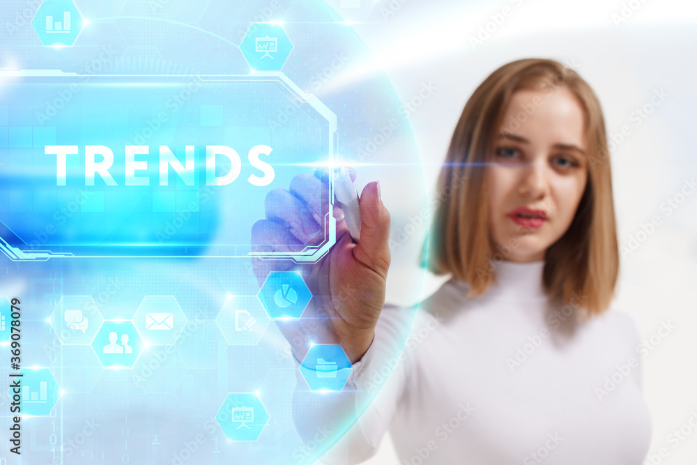 Business, Technology, Internet and network concept. Young businessman working on a virtual screen of the future and sees the inscription: Trends Business, Technology, Internet and network concept. Young businessman working on a virtual screen of the future and sees the inscription: Trends