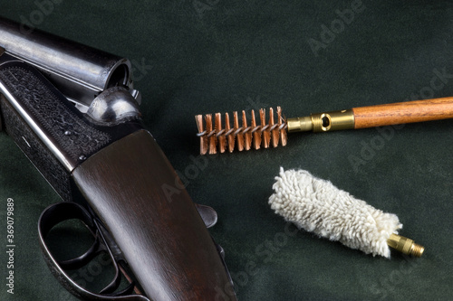 Old Shotgun on Outdoor Coat with Cleaning Equipment photo