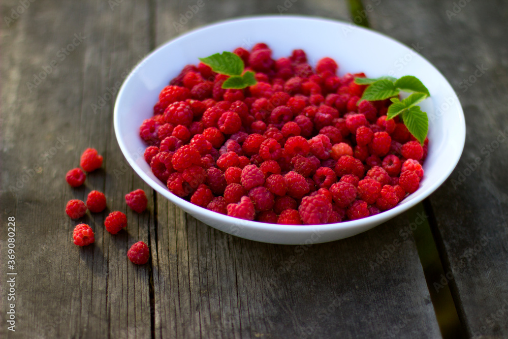 Red fresh raspberries with green leaves in a white misk on a wooden background with copy space.
Healthy snack. Summer healthy food concept. Healthy organic sweet fruits. Red fresh raspberries with green leaves in a white misk on a wooden background with copy space.
Healthy snack. Summer healthy food concept. Healthy organic sweet fruits.