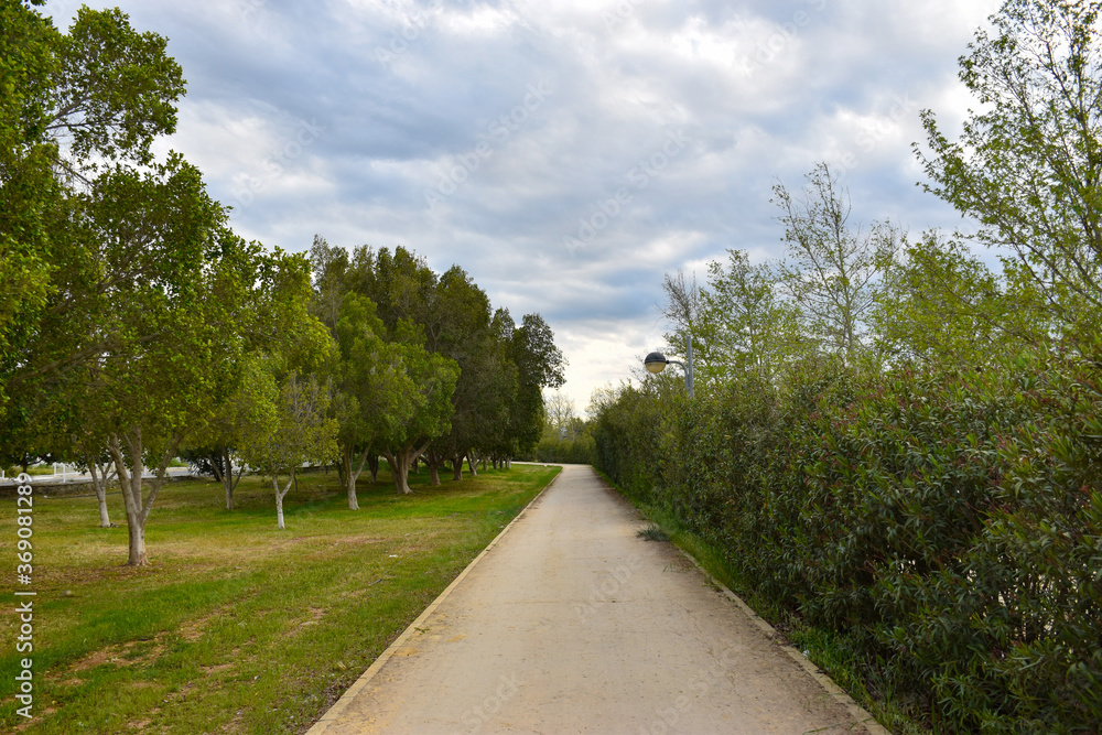 Beautiful cycle and walking path in Nicosia, Cyprus on a cloudy day with green trees and grass
