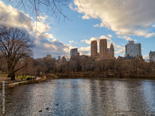 The central park, New York city daylight view with people walking, new York skyline , clouds and trees	