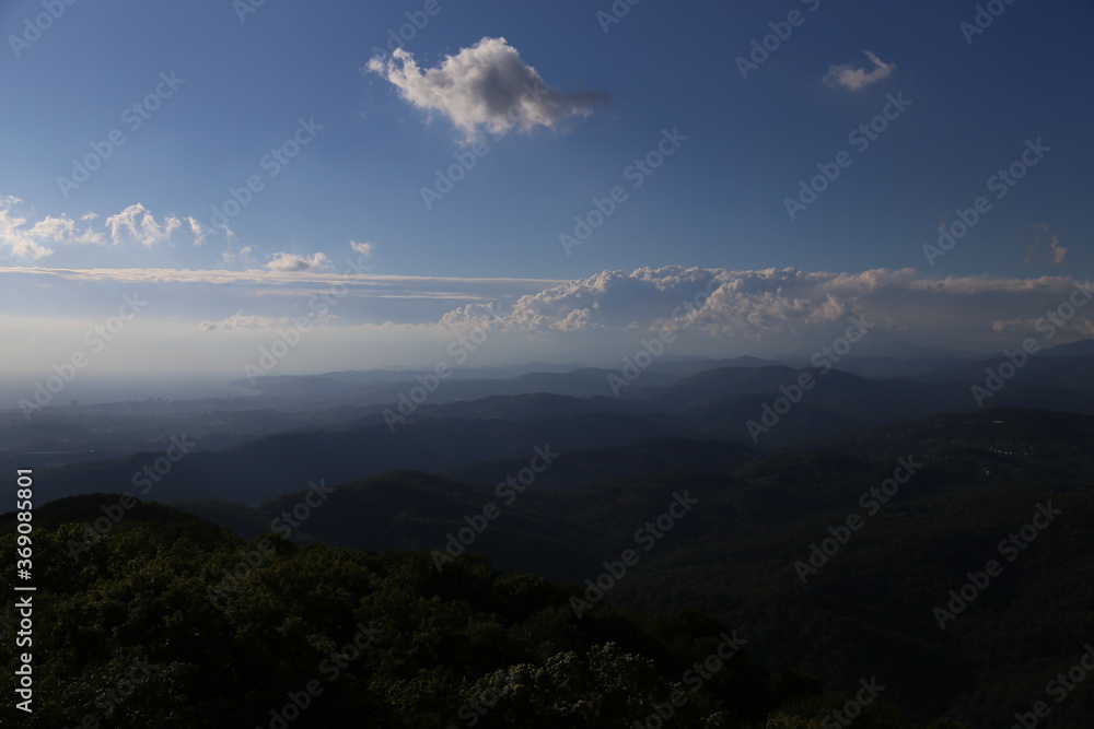 landscape. clouds over the mountains. forest.