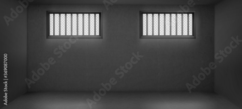Fotografiet Prison cell with barred windows, empty jail interior with grey concrete walls and sun rays falling on floor