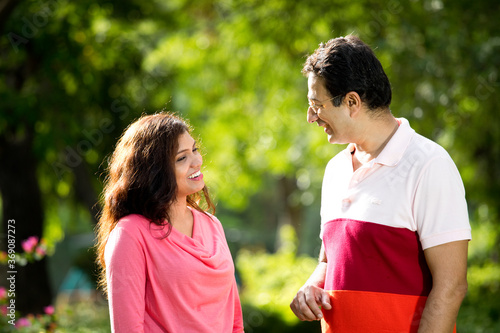 Mid adult couple discussing at public park
