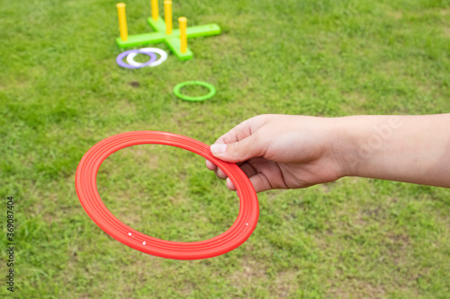 Fotografiet children's play ring toss on green grass