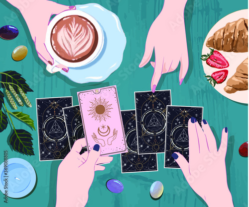 A session with a fortune teller with tarot cards, the interpreter's female hands lay out the suits of cards of fate for their guest, drink coffee and wait on arcane cards at the mystical guide
