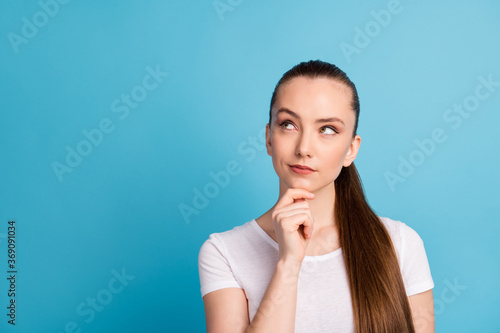 Photo of smart girl look copyspace touch hand face think thoughts decide decision wear casual style clothes isolated over blue color background