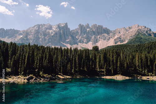 incredible emerald mountain lake framed by spruce forest and dolomite mountains