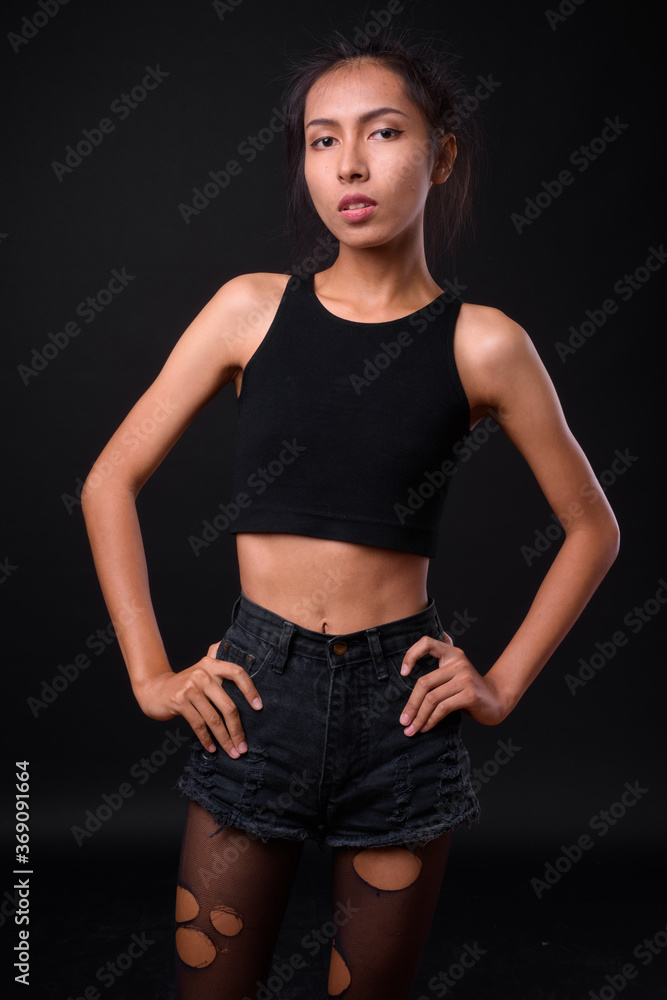 Young beautiful Asian transgender woman against black background Young beautiful Asian transgender woman against black background