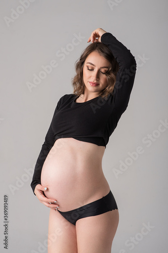 Studio portrait of beautiful pregnant woman. photo