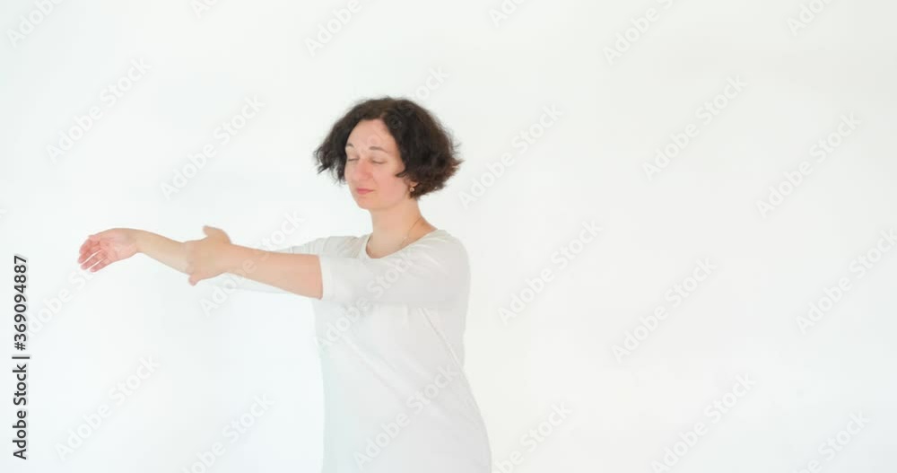 woman practicing qi qong at white studio traditional chinese gymnastics woman practicing qi qong at white studio traditional chinese gymnastics