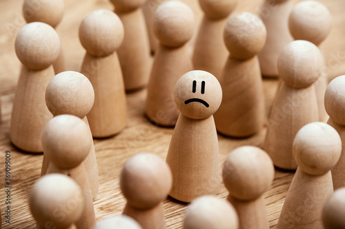 Murais de parede Standing out isolated and sad in the middle of a crowd