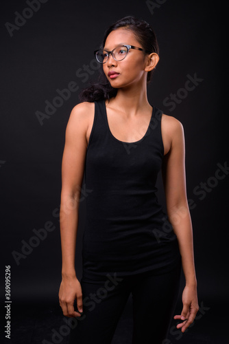 Portrait of young beautiful Asian woman with eyeglasses