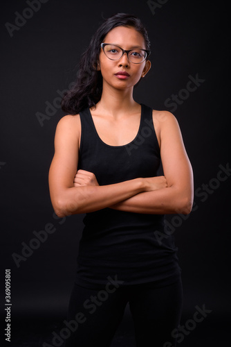 Portrait of young beautiful Asian woman with eyeglasses